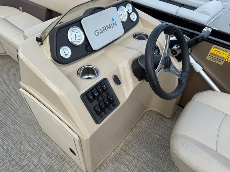 Slide: The Image of 2023 Bentley Pontoons LE 200 dashboard with Garmin display and steering wheel. - 10