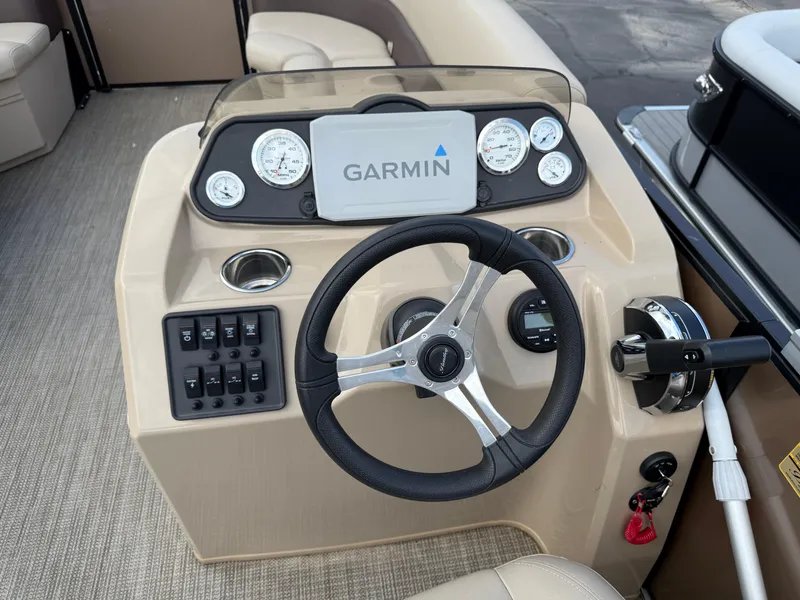 Slide: The Image of 2023 Bentley Pontoons LE 200 dashboard with Garmin display and steering wheel. - 12