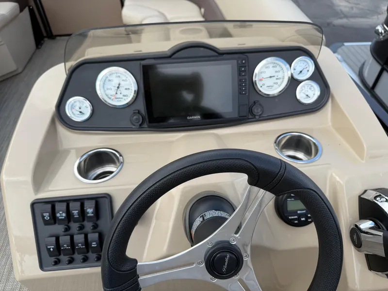 Slide: The Image of 2023 Bentley Pontoons LE 200 dashboard with steering wheel, gauges, and controls. - 13