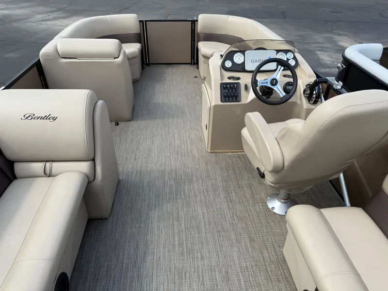 Slide: The Image of 2023 Bentley Pontoons LE 200 interior with beige seating and modern dashboard. - 19