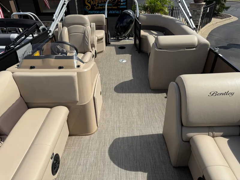 Slide: The Image of 2023 Bentley Pontoons LE 200 interior with beige seating and steering console. - 5