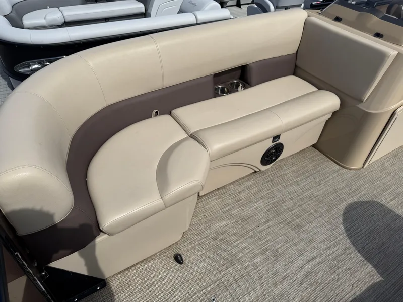 Slide: The Image of 2023 Bentley Pontoons LE 200 interior seating with beige upholstery and cup holders. - 6