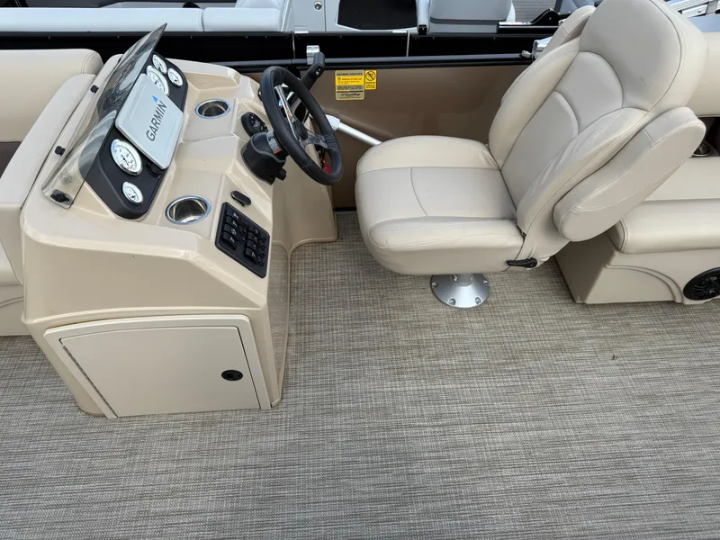 Slide: The Image of 2023 Bentley Pontoons LE 200 helm with beige captain's chair and Garmin navigation system. - 9