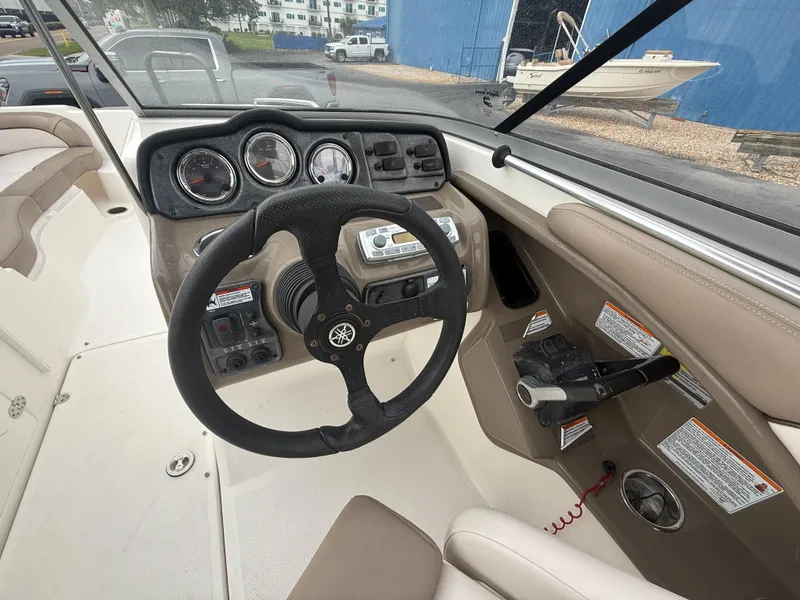 Slide: The Image of 2011 Yamaha Boats SX240 HO dashboard with steering wheel and control panel. - 5
