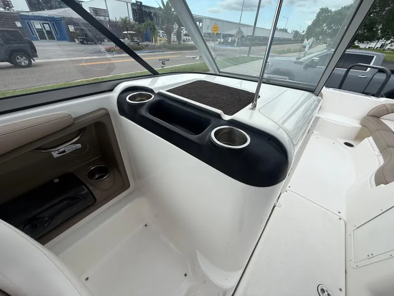 Slide: The Image of Interior of a 2011 Yamaha Boats SX240 HO, featuring cup holders and seating area. - 7