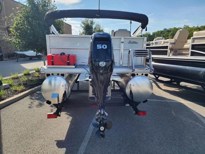 Slide: The Image of 2026 Sun Tracker Party Barge 16 pontoon boat with Mercury 50 engine, parked outdoors. - 3