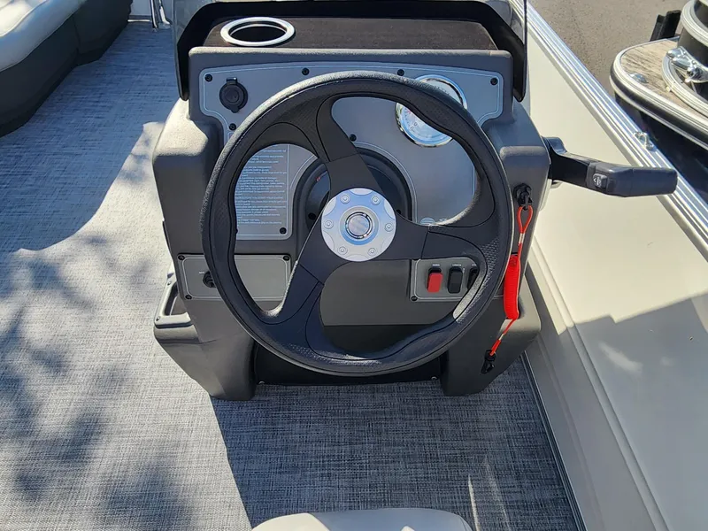 Slide: The Image of Steering console of 2026 Sun Tracker Party Barge 16 pontoon boat, featuring modern controls. - 6