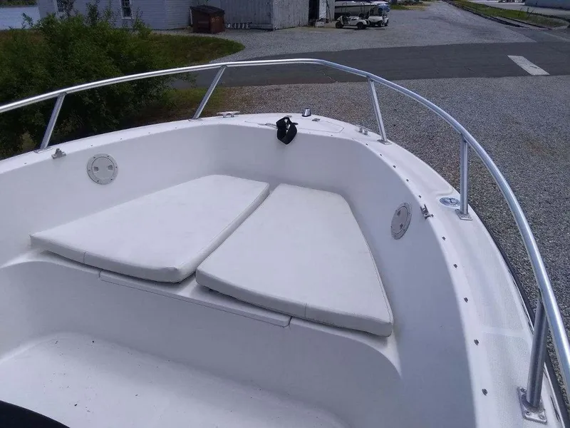 Slide: The Image of 2001 Mako 192 Center Console boat with cushioned bow seating and stainless steel railing. - 10