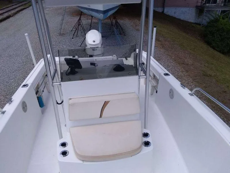 Slide: The Image of 2001 Mako 192 Center Console boat interior with seating and steering console. - 11