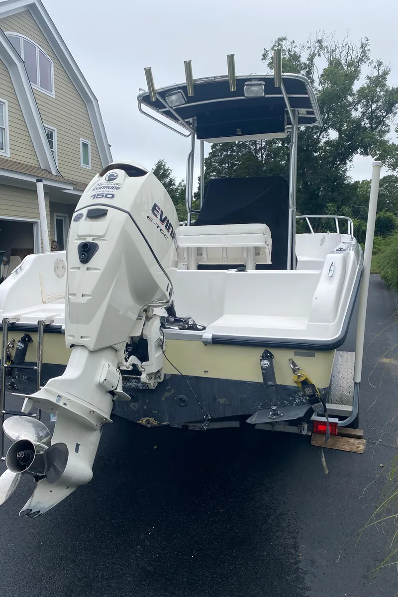 Slide: The Image of 2001 Mako 192 Center Console boat with Evinrude 150 outboard motor on driveway. - 3