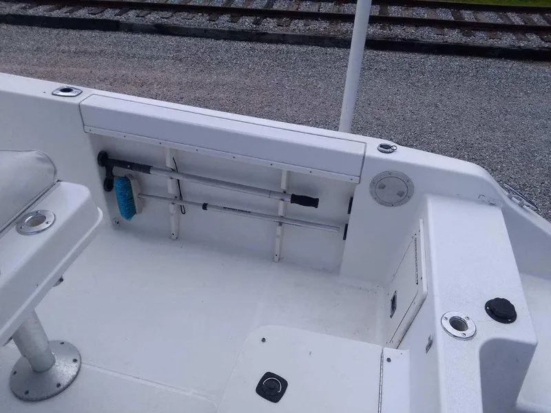 Slide: The Image of 2001 Mako 192 Center Console boat interior with storage and cleaning tools. - 7