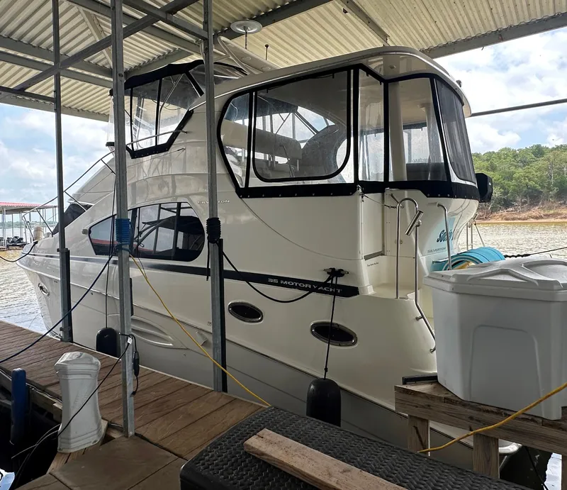 The Image of 2008 Silverton 35 Motor Yacht docked under a covered marina. - 0