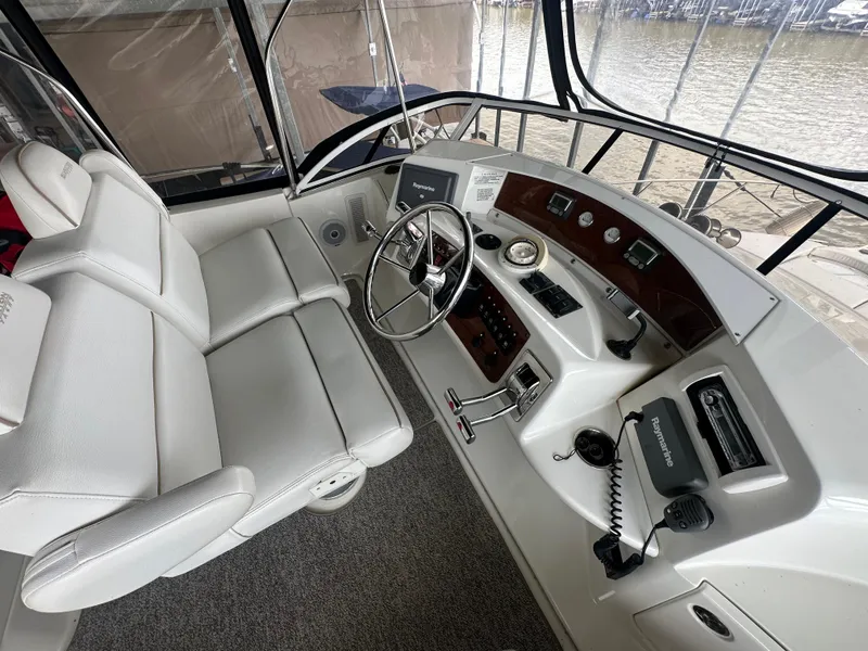 Slide: The Image of 2008 Silverton 35 Motor Yacht helm with steering wheel, controls, and navigation equipment. - 11