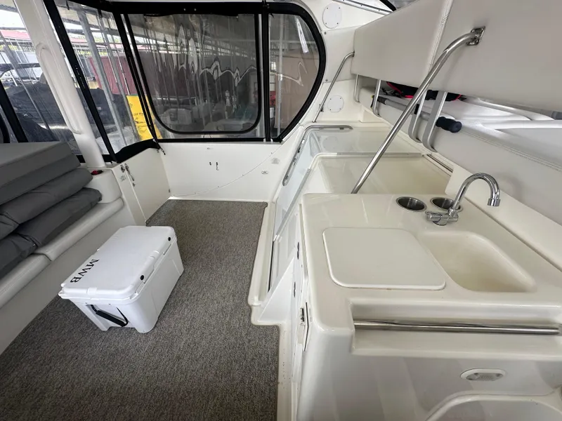 Slide: The Image of 2008 Silverton 35 Motor Yacht interior with kitchenette, seating, and cooler. - 17