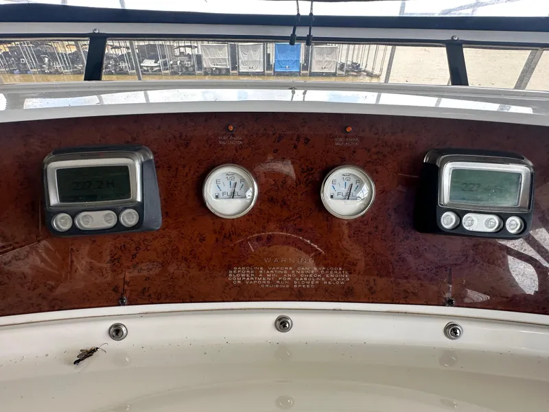 Slide: The Image of Dashboard of a 2008 Silverton 35 Motor Yacht with fuel gauges and digital displays. - 18