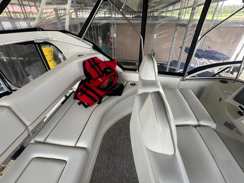 Slide: The Image of Interior of 2008 Silverton 35 Motor Yacht with white seating and red life jackets. - 19