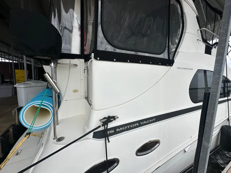 Slide: The Image of 2008 Silverton 35 Motor Yacht docked, featuring sleek design and spacious deck area. - 2