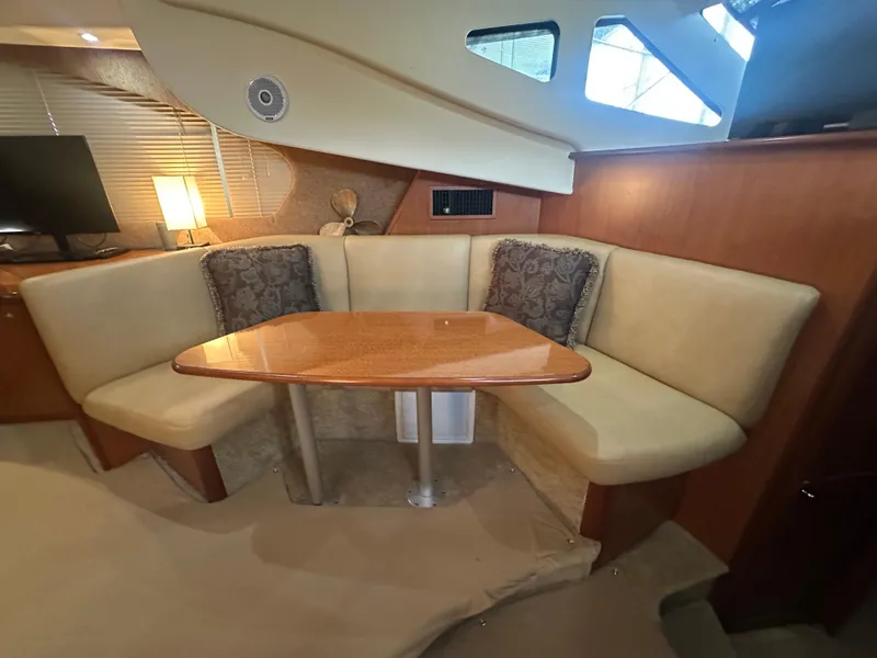 Slide: The Image of 2008 Silverton 35 Motor Yacht interior with cozy dining area and elegant wood table. - 23
