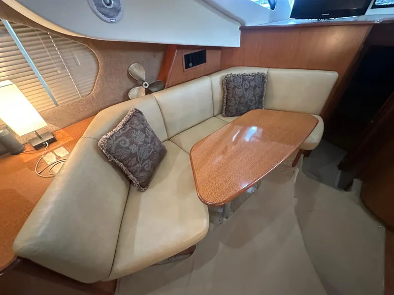 Slide: The Image of 2008 Silverton 35 Motor Yacht interior with beige seating and wooden table. - 25