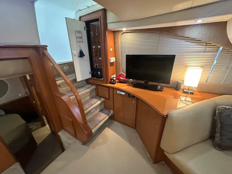 Slide: The Image of Interior of 2008 Silverton 35 Motor Yacht with TV, stairs, and cozy seating area. - 32
