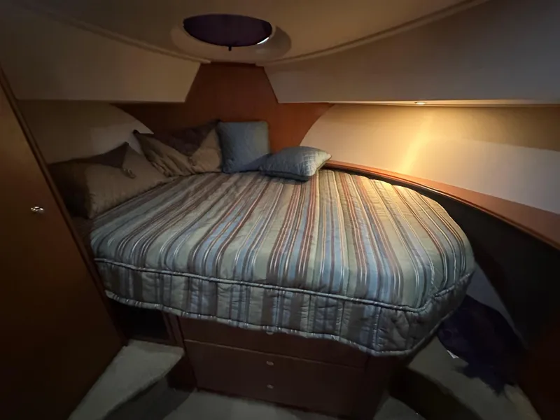 Slide: The Image of 2008 Silverton 35 Motor Yacht bedroom with cozy bed and ambient lighting. - 34