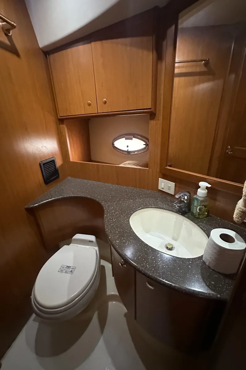 Slide: The Image of 2008 Silverton 35 Motor Yacht bathroom with wood cabinetry and modern fixtures. - 36