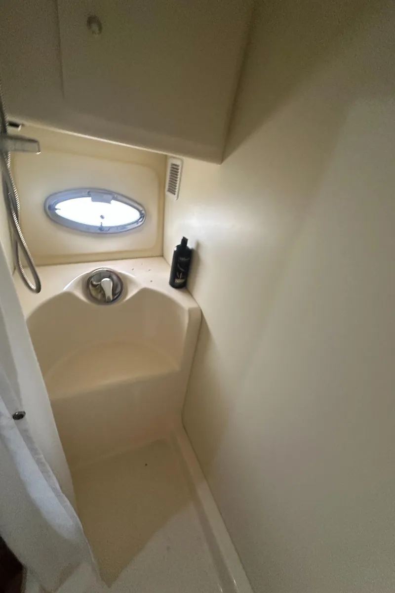 Slide: The Image of Shower area in 2008 Silverton 35 Motor Yacht with porthole and toiletries. - 37