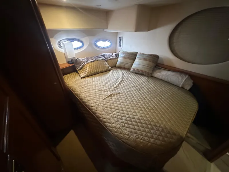 Slide: The Image of Cozy bedroom in 2008 Silverton 35 Motor Yacht with quilted bedding and porthole windows. - 41