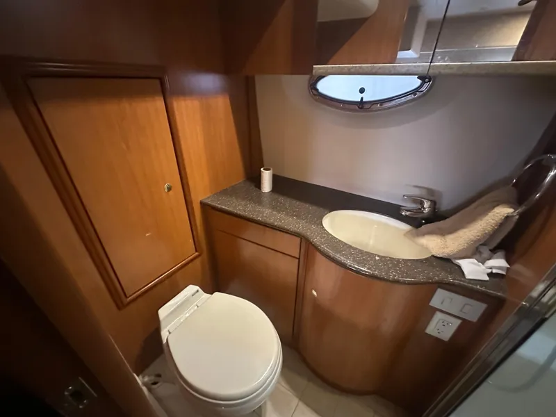 Slide: The Image of 2008 Silverton 35 Motor Yacht bathroom with wooden cabinetry, sink, and toilet. - 45