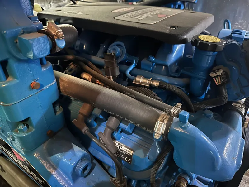 Slide: The Image of Engine of a 2008 Silverton 35 Motor Yacht, featuring blue components and various hoses. - 49