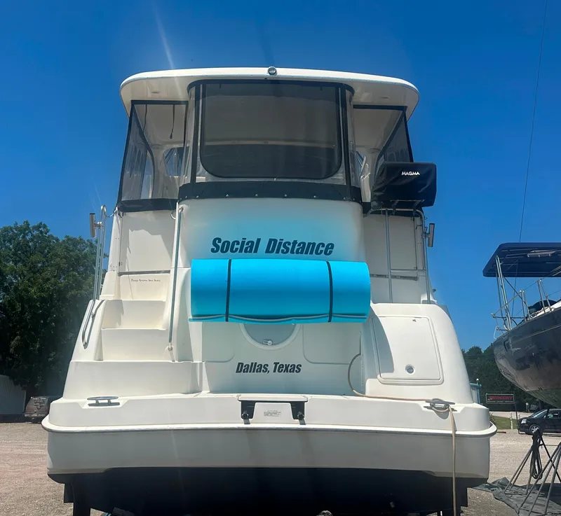 Slide: The Image of 2008 Silverton 35 Motor Yacht named "Social Distance" in Dallas, Texas, under clear blue sky. - 7