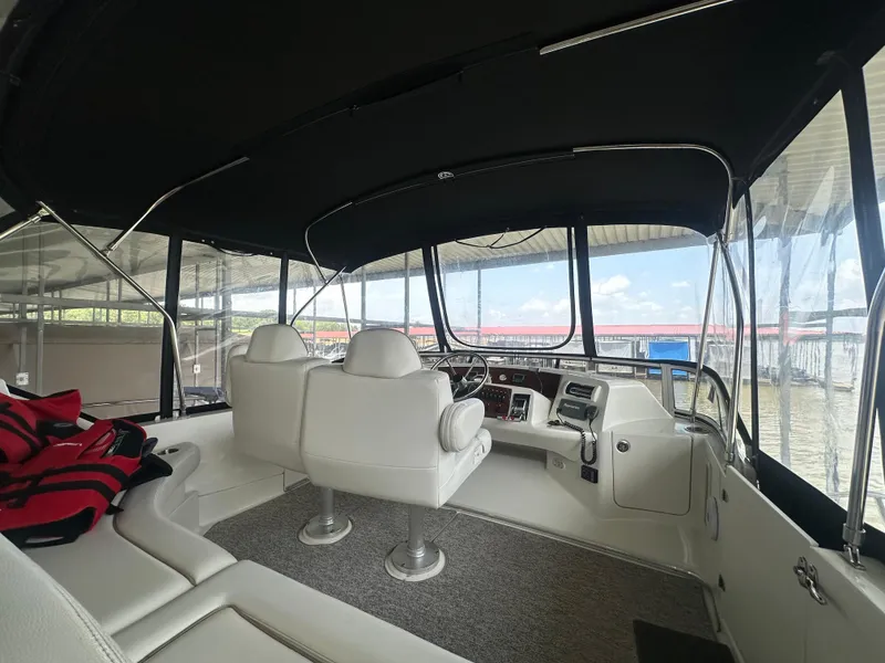 Slide: The Image of Interior of 2008 Silverton 35 Motor Yacht with white seating and helm controls. - 8