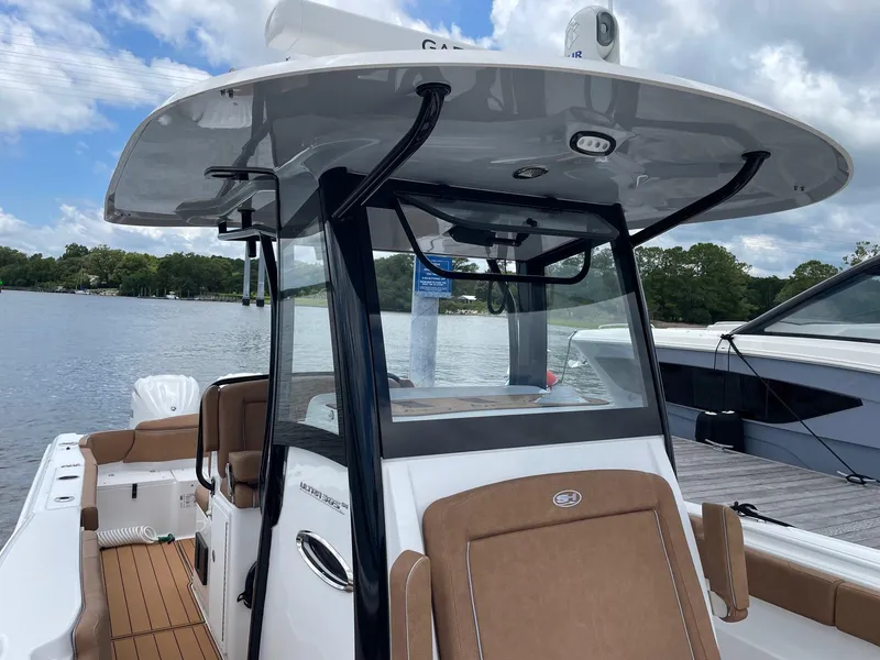 Slide: The Image of 2024 Sea Hunt Ultra 305 SE boat on water, featuring sleek design and comfortable seating. - 15