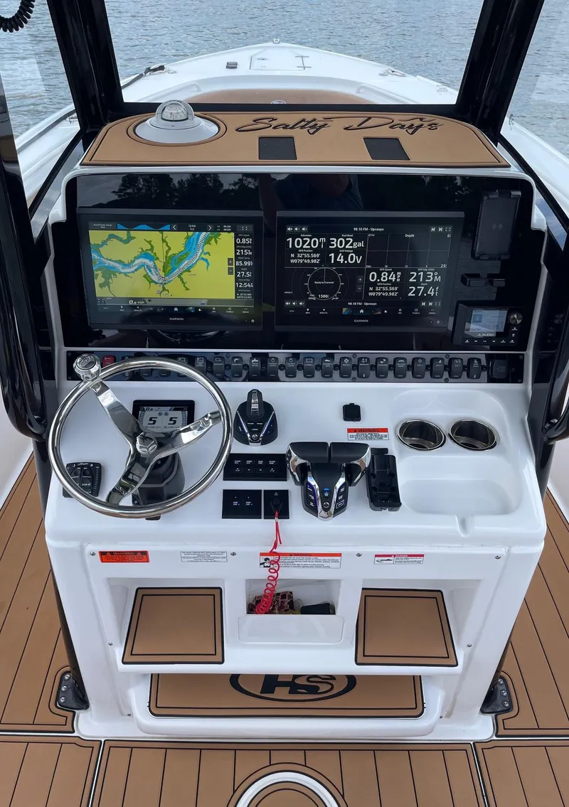Slide: The Image of 2024 Sea Hunt Ultra 305 SE boat dashboard with navigation screens and controls. - 17