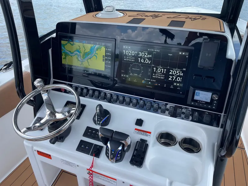Slide: The Image of 2024 Sea Hunt Ultra 305 SE dashboard with navigation screens and controls. - 18