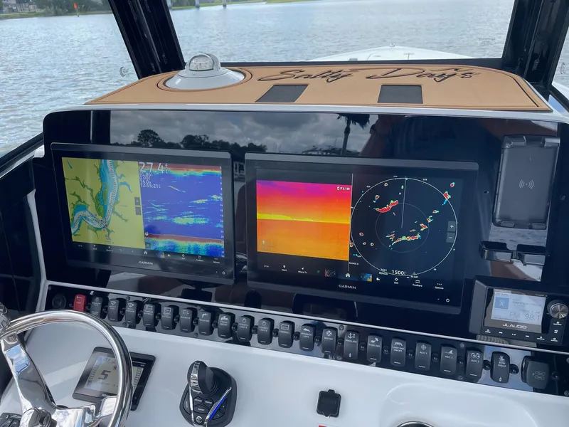 Slide: The Image of 2024 Sea Hunt Ultra 305 SE dashboard with advanced navigation and control systems. - 19