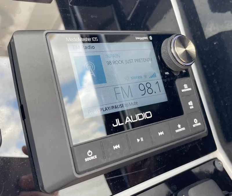 Slide: The Image of JL Audio MediaMaster 105 displaying FM radio on Sea Hunt Ultra 305 SE, 2024 model. - 22