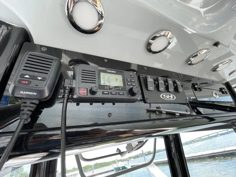 Slide: The Image of 2024 Sea Hunt Ultra 305 SE dashboard with Garmin marine electronics and control panel. - 24