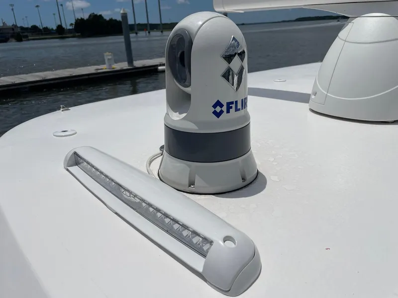Slide: The Image of 2024 Sea Hunt Ultra 305 SE boat with FLIR camera and LED light on deck. - 28