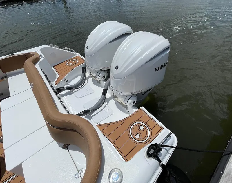 Slide: The Image of 2024 Sea Hunt Ultra 305 SE boat with dual Yamaha outboard engines on water. - 39