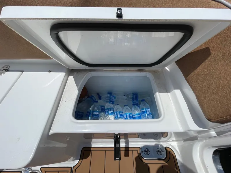 Slide: The Image of Built-in cooler with bottled water on 2024 Sea Hunt Ultra 305 SE boat. - 43