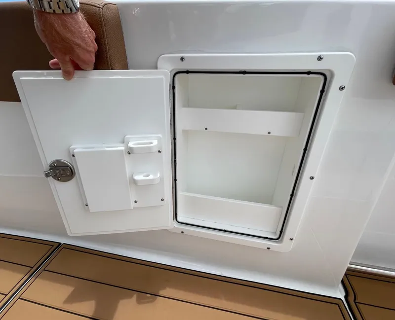 Slide: The Image of Open storage compartment on 2024 Sea Hunt Ultra 305 SE boat deck. - 45