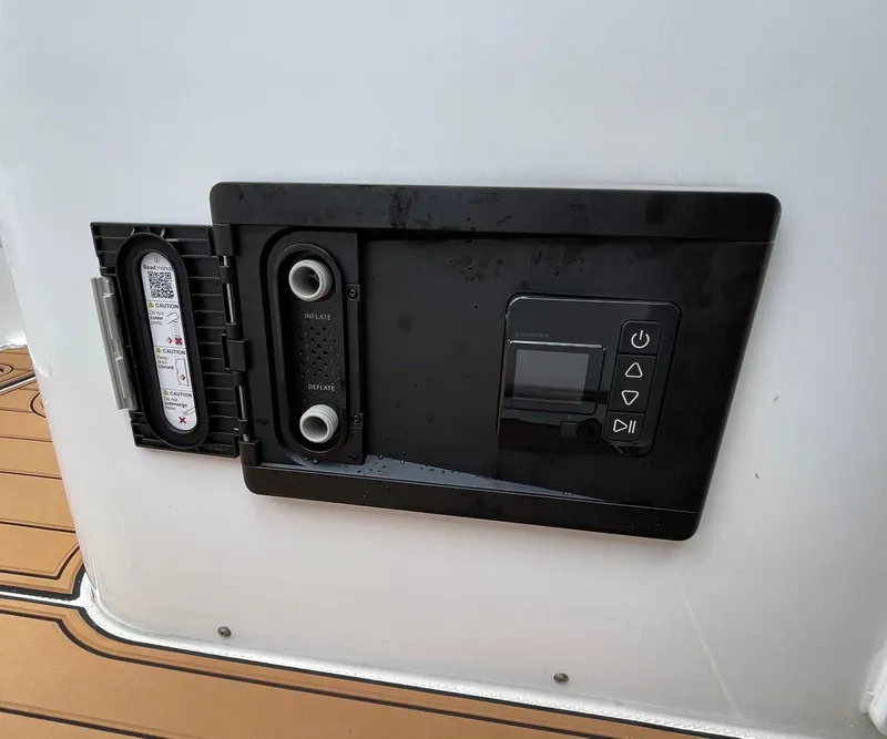 Slide: The Image of Control panel on 2024 Sea Hunt Ultra 305 SE boat, featuring inflate and deflate options. - 48