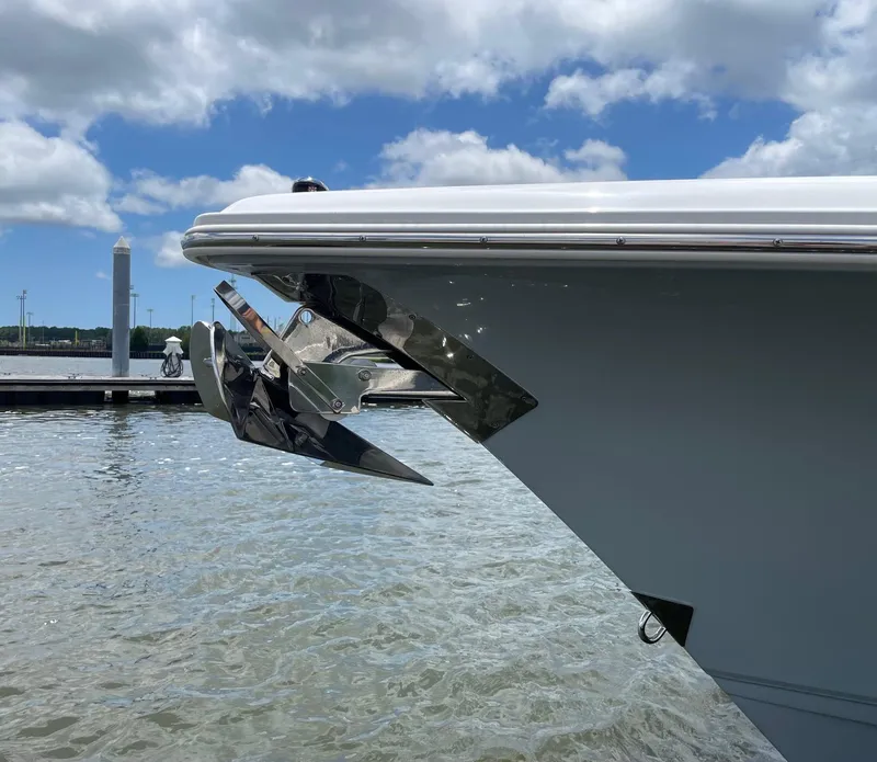 Slide: The Image of 2024 Sea Hunt Ultra 305 SE boat bow with anchor, docked on a sunny day. - 49