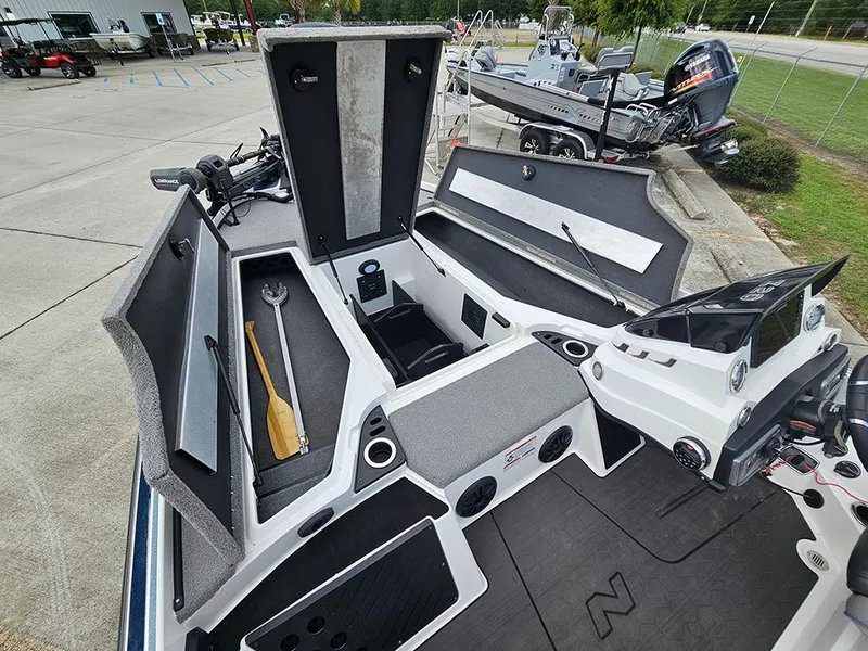 Slide: The Image of 2023 Nitro Z20 Pro boat interior with open storage compartments and fishing gear. - 18
