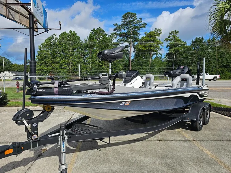 Slide: The Image of 2023 Nitro Z20 Pro bass boat on trailer, parked outdoors under blue sky. - 2