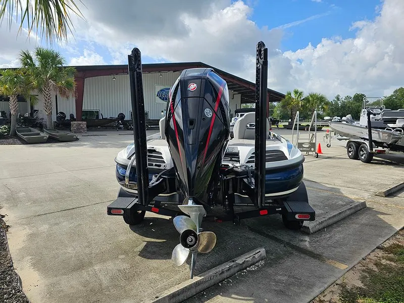 Slide: The Image of 2023 Nitro Z20 Pro boat with powerful outboard motor, parked outdoors under a cloudy sky. - 8