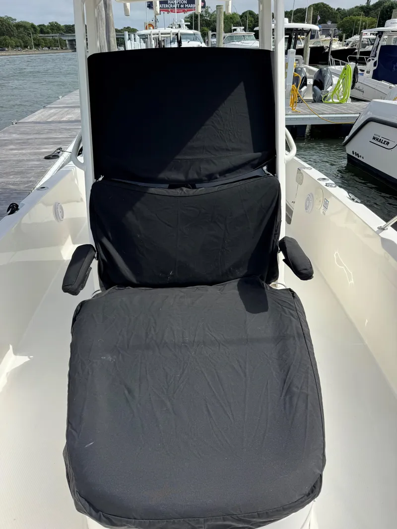 Slide: The Image of 2017 Boston Whaler 270 Dauntless boat seat with black cover at marina. - 10