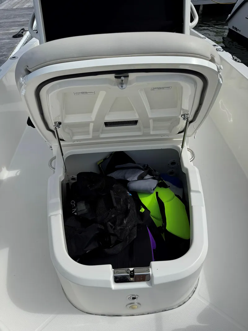 Slide: The Image of Open storage compartment on 2017 Boston Whaler 270 Dauntless boat with gear inside. - 11