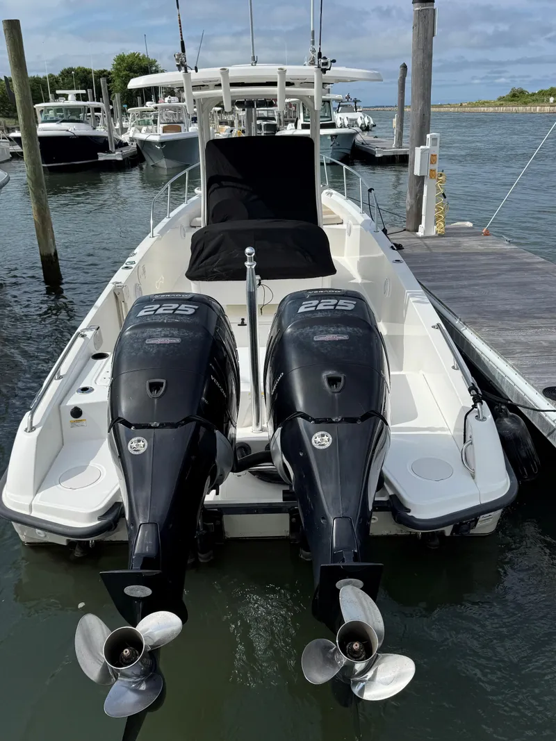 Slide: The Image of 2017 Boston Whaler 270 Dauntless with twin 225 engines docked at marina. - 2